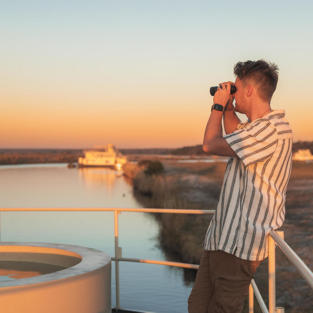Chobe Princess Guest looking through binoculars