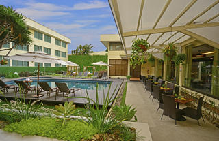 Covered terrace and outdoor siwming pool.