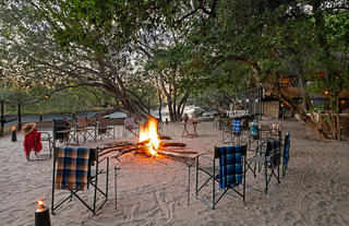 Fire pit setup with beach dinner