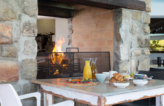 Breakfast table for the guests in front of the fireplace
