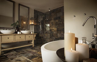 A luxurious en-suite bathroom with soaking tub and separate "rain" shower