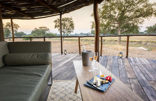 Lion Camp - Deluxe Suite - sofa on deck with drnks