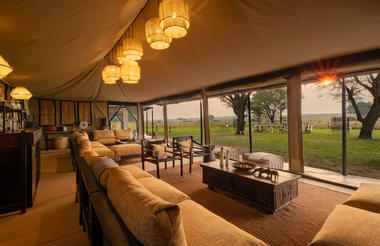 Ubuntu Camp - Main area lit up with sun peaking through at sunset