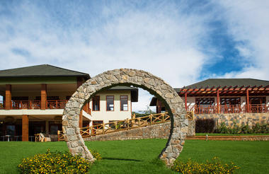 The iconic Arc on a beautiful garden in front of the main bar and coffee bar (downstairs on the left building) and the restaurant (the right building.