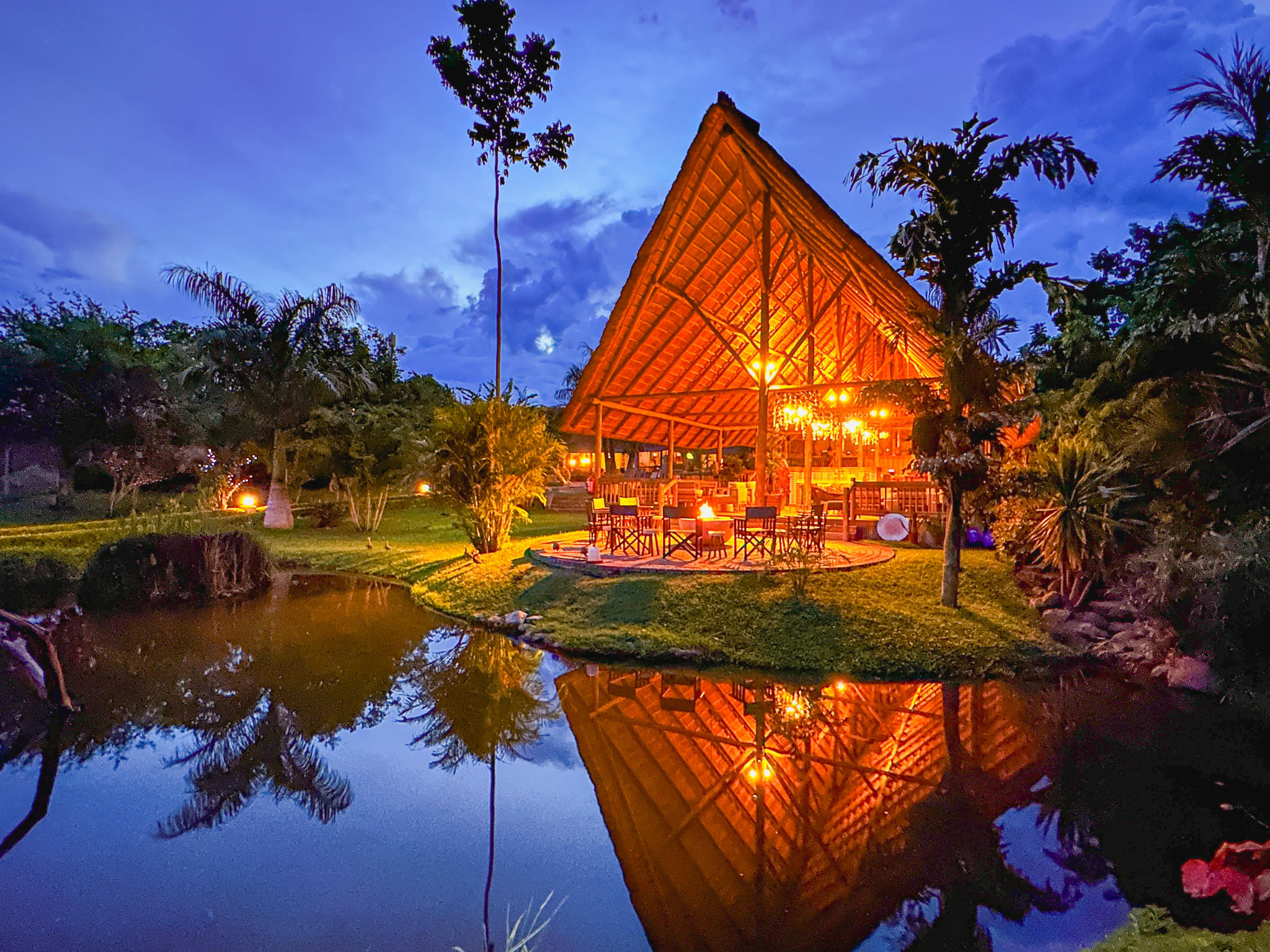 Open-air lodge and landscaped grounds at Shearwater Explorers Village after dark