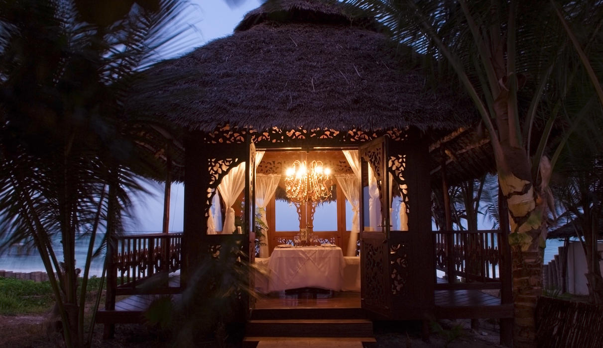 Private beachfront dining for two in an intimate setting overlooking the India Ocean, offering personalized service and a special menu for two.