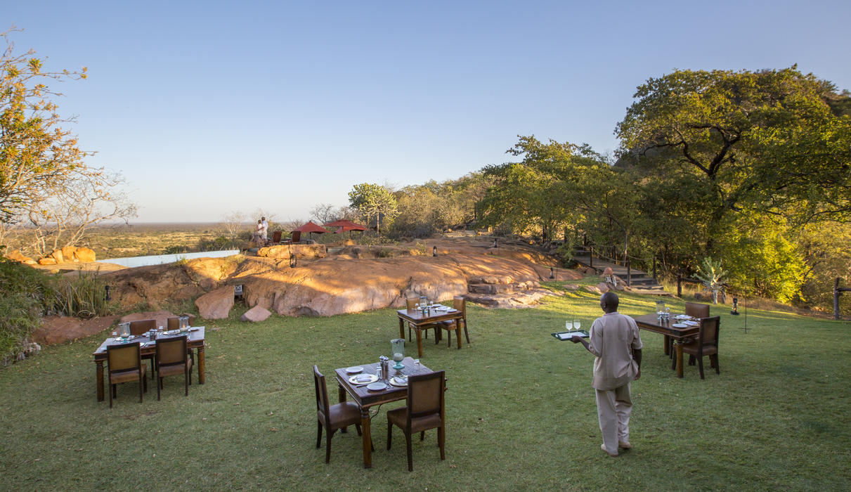 Dining out on the lawns, with views over the infinity pool to Meru plains beyond