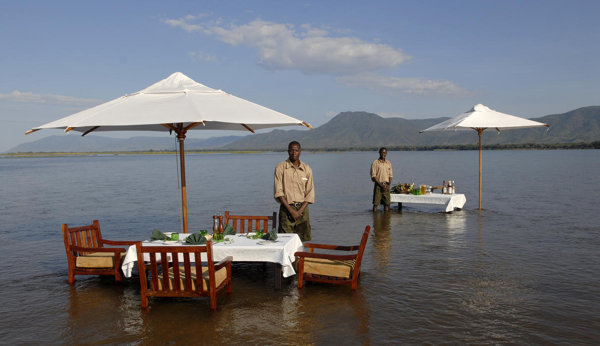 Dine with your toes in the Zambezi River 