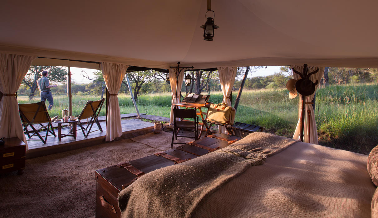 Large tents decorated in traditional safari-style furniture 