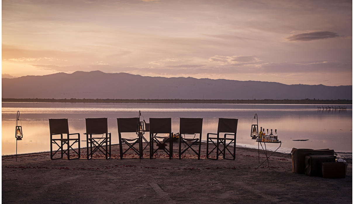 Enjoy a sundowner at the end of the day on Lake Burunge