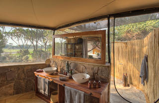 Roho ya Selous - Guest tent bathroom leading to outdoor shower