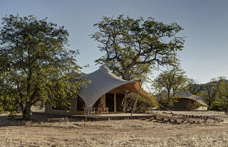 Canvas covered tents for guests.