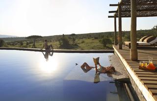 relaxing by the heated infinity pool at the spa village