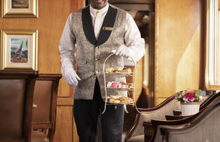 Butler serving high tea in Lounge Car