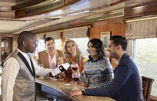 Guests being served at the bar in the Lounge Car