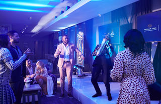 Guests enjoying entertainment  at VIP pre-departure lounge