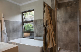 Superior suite bathroom with view of a small garden