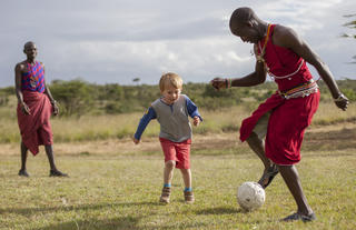Asilia Africa | Encounter Mara - Children playing outside with Askari