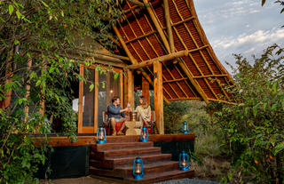 Naboisho Camp - Guests relaxing on tent deck
