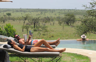 Naboisho Camp - Guests relaxing at the pool
