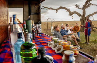 Naboisho Camp - Guests enjoying bush bar setup