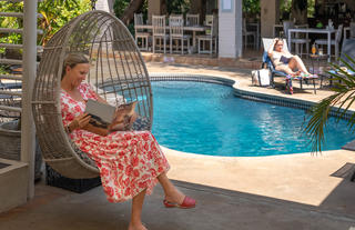 hanging basket chair overlooking the pool