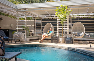 hanging basket chairs in the outdoor pool seating area