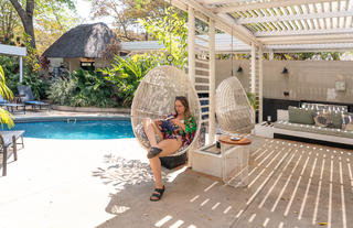 Comfortable hanging basket chairs to relax in by the pool