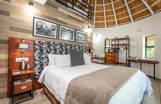 Family Room with King bed downstairs and 3 single beds upstairs in the loft area