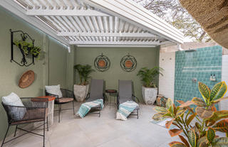 Honeymoon room private patio with outdoor shower, seating area and sun loungers