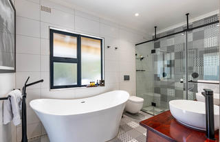 Honeymoon Room en suite bathroom with slipper bath, double vanity and double shower