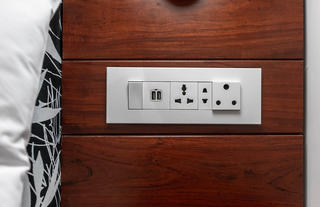 International plug sockets on room headboard