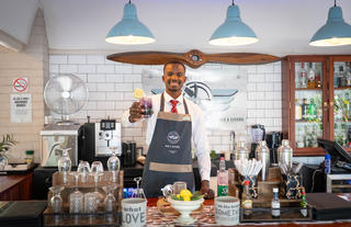 Waiter serving drinks at the Prop & Rotor Bar