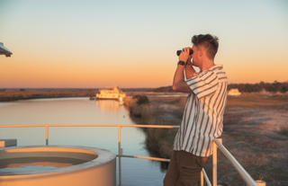 Chobe Princess Guest looking through binoculars