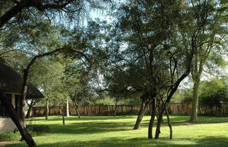 Green, shady lawns surround the main house and the deck area
