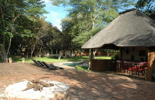 The boma and pool area looking onto the main house and accommodation