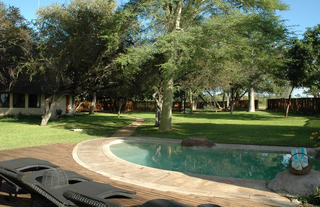 The pool and deck area with the main camp in the background