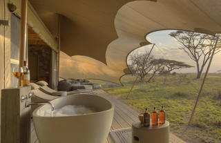 Namiri Plains - Tent Deck with Bath, Sunbeds and Cushion Corner