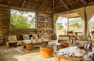 The sun-slatted main mess area at Kuro is a comfortable spot to curl up with some binos and a good book in between forays into the wilds of Tarangire. 