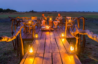 Sundowner drinks around the fireplace.