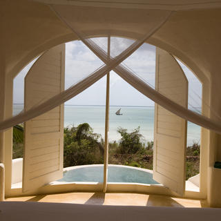 Shuttered windows of a pavilion with views to the azure Indian Ocean