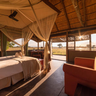 The rooms are spacious and offer views across the waterhole in front of camp