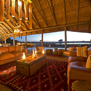 Camp Hwange main lounge area offers comfort and enchanting views over the waterhole