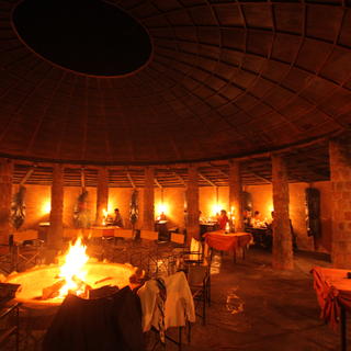 Ein Drei-Gänge-Buffet-Abendessen wird am Lagerfeuer unter dem Sternenhimmel Afrikas im traditionellen Lapa serviert.