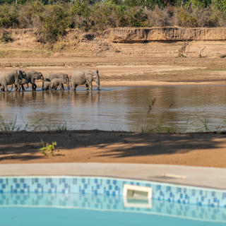 Time + Tide Mchenja&#039;s pool overlooking the river and its visitors