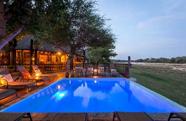 Umkumbe's deck and swimming pool at dusk