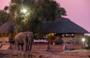 Main lodge view from waterhole at night