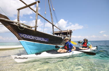 Guest kayaking with the support Dhow 