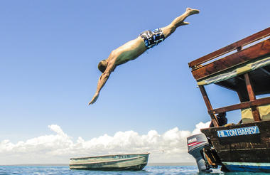 Guest going for a swim while on Dhow Safari 
