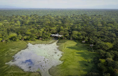 Render: Overhead view of Chicari camp between the trees, overlooking the pan